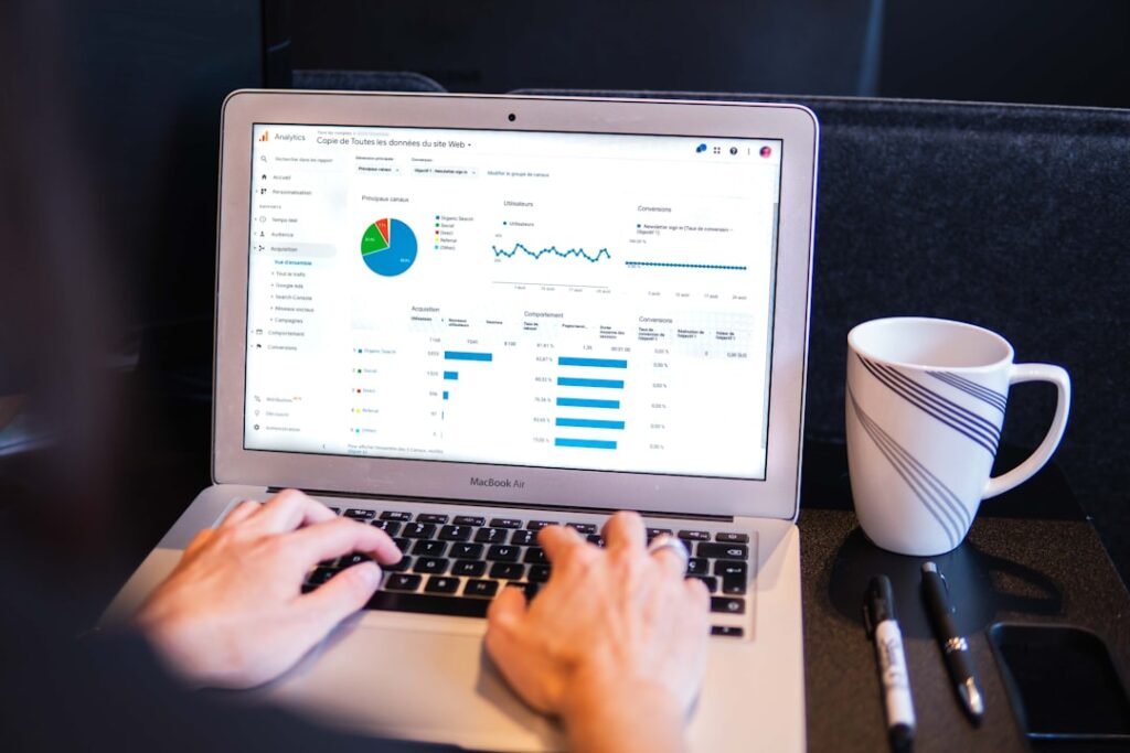 Google Analytics overview dashboard on a laptop screen showing conversion metrics, bounce rate, and traffic data