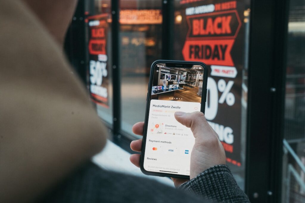 Person holding a smartphone displaying a mobile ecommerce checkout interface