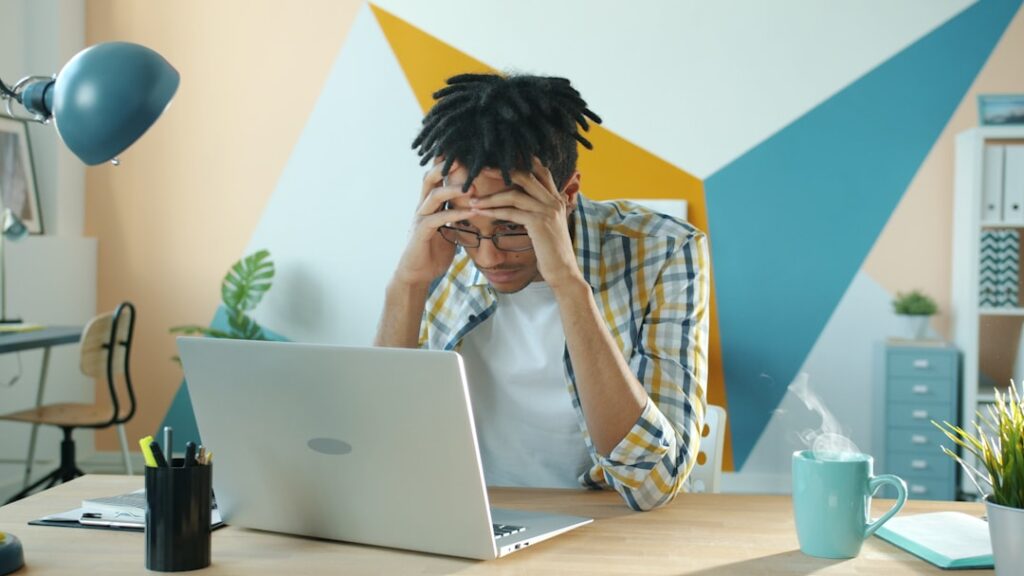 Frustrated marketer looking at a laptop screen, representing the poor results caused by common landing page mistakes